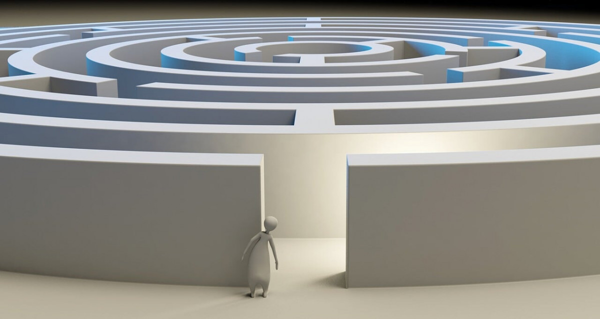 3D rendering of a person stood at the edge of a maze