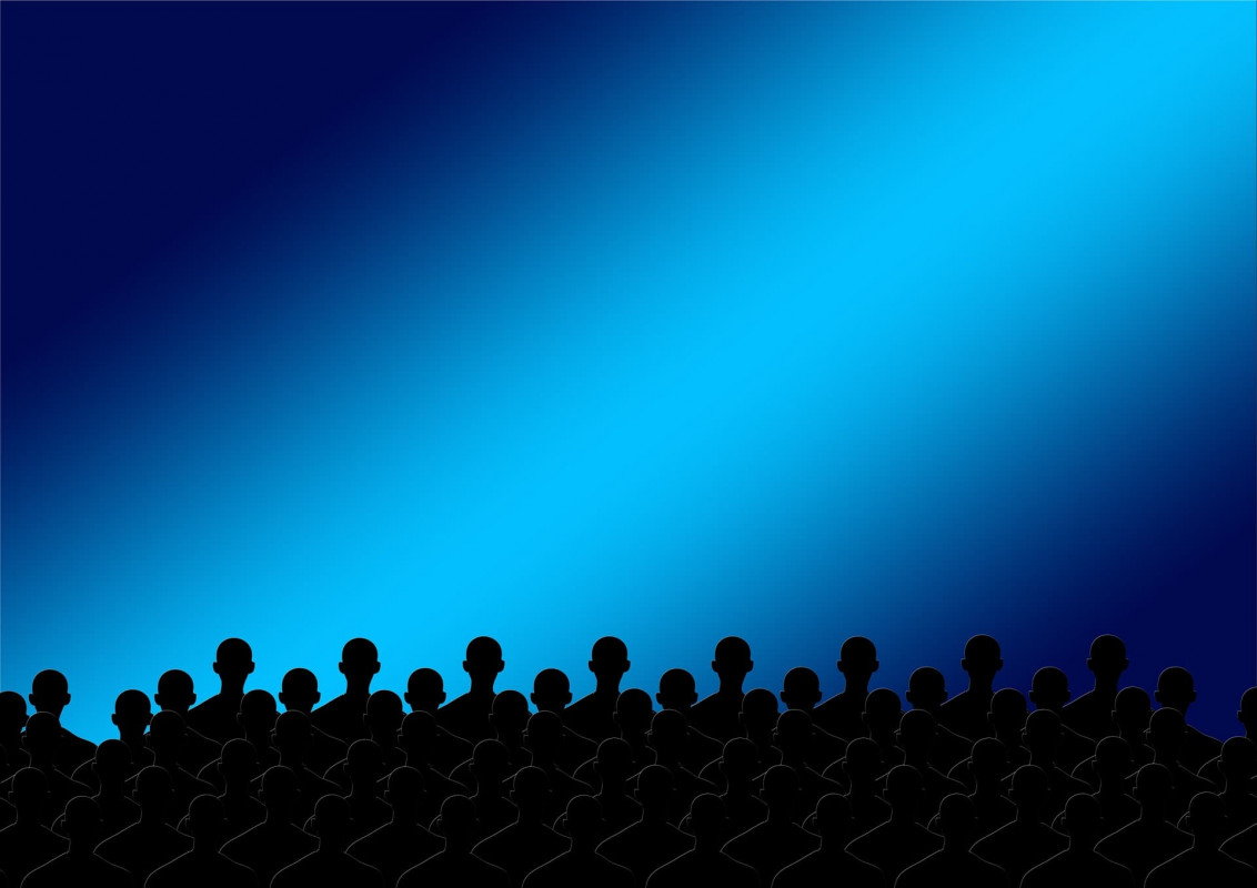 A silhouette of a cartoon audience against a graduated blue background