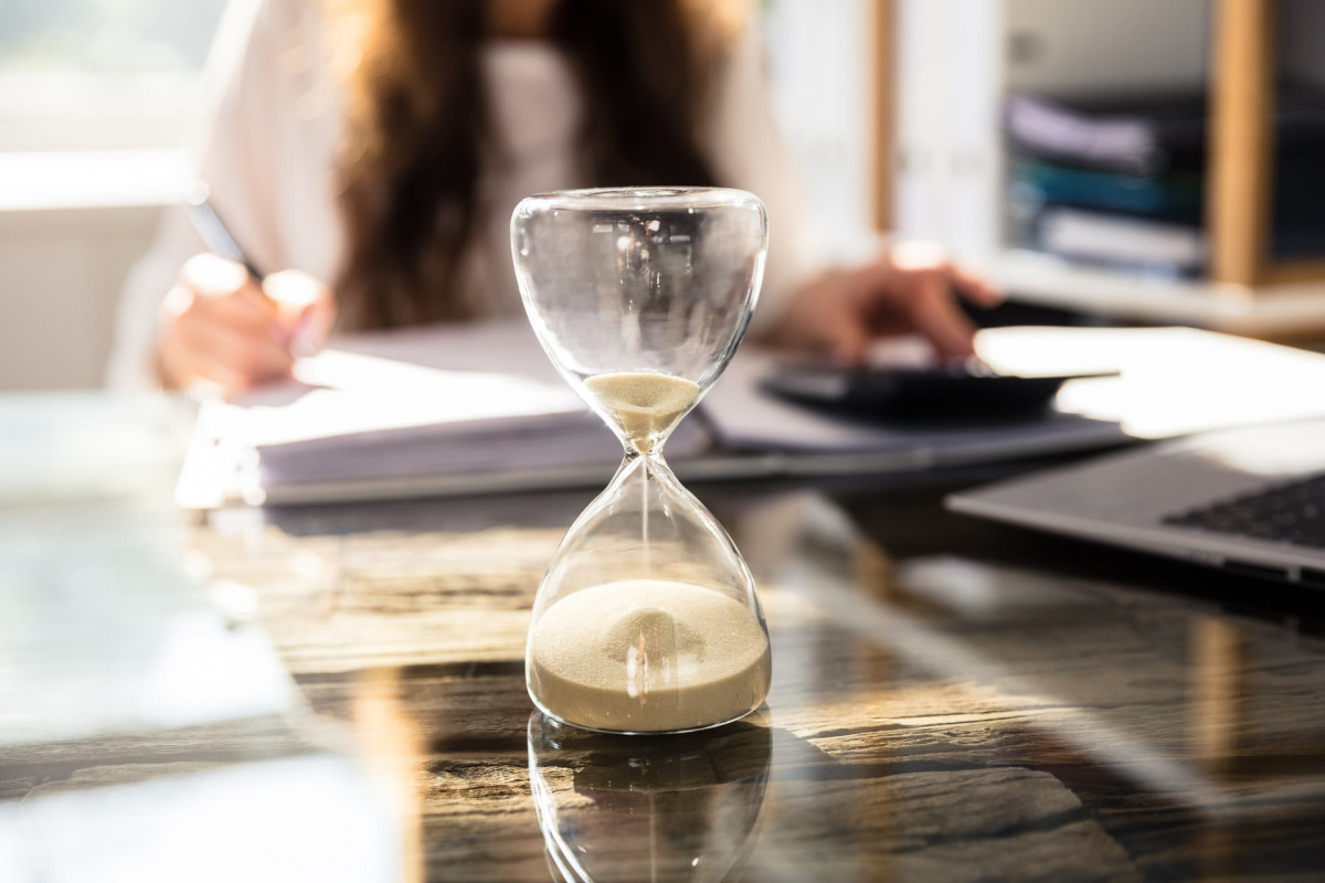 Egg timer counting down with a person working in the background