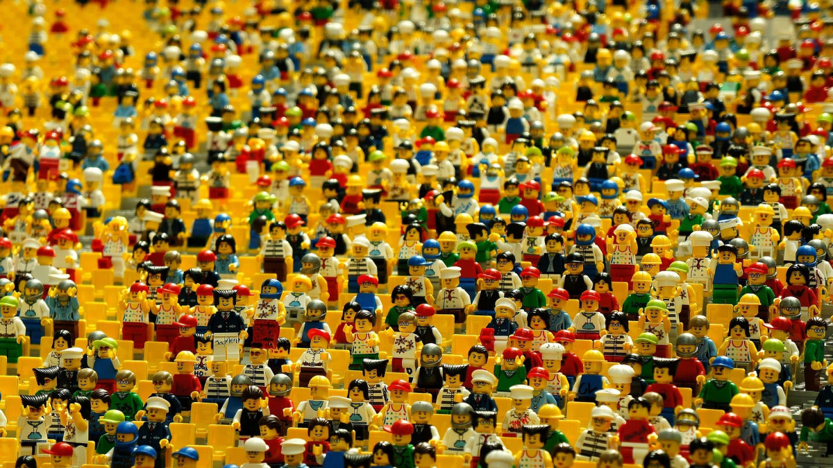 Hundreds of Lego figures wearing different things and with different hats on to show variety