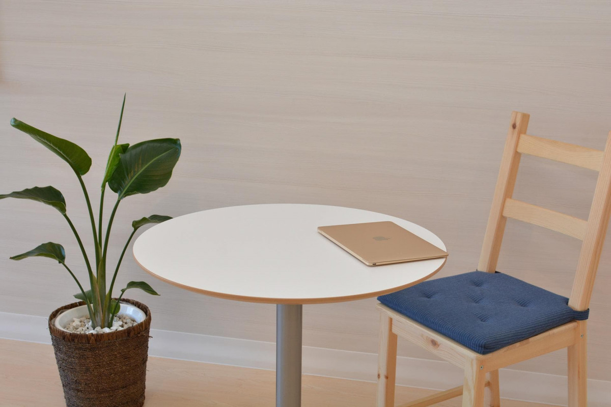 Laptop on a table in a sparse room