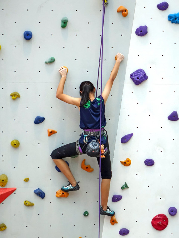 Person using a roped climbing wall