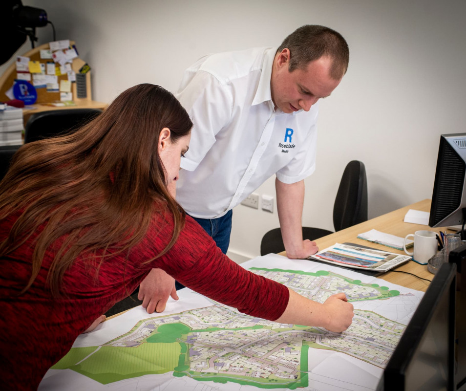 Siân and Mathew reviewing a plan for an upcoming project